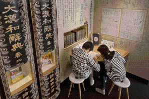 「大漢和辞典」の横にある読書コーナーで本を読む児童たちの写真
